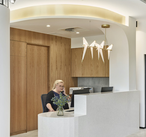 Functional medical rooms, neutral and wooden colour palette and welcoming reception area for this medical fit out for Queensland Orthopaedic Clinic