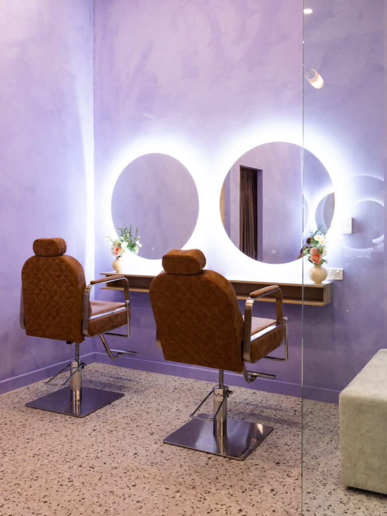 Custom LED signage, circular LED backlit mirrors and purple and neutral colour palette for this wellness and beauty fit out for Elegant Brows