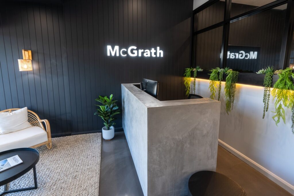 Elevated ceilings, coastal neutral colour palette and inviting reception area for this office fit out for McGrath Nowra, Total Fitouts Illawarra