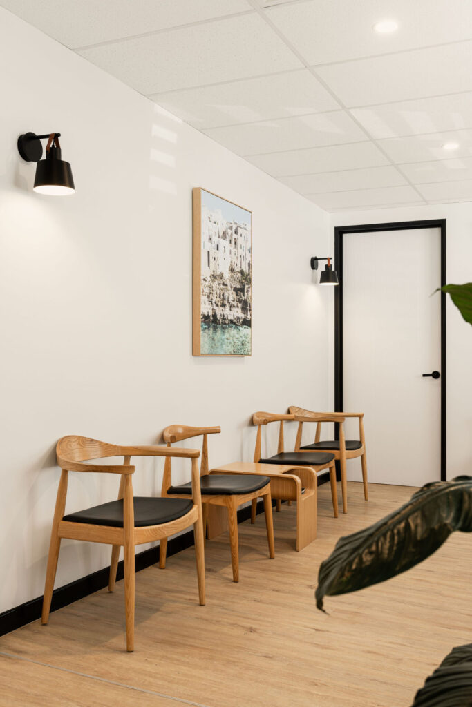 Black and white optometry equipment, a coastal-inspired aesthetic and sleek black wall lights for this medical fit out for Insight Eye Surgery, Total Fitouts Sunshine Coast South
